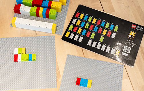 LEGO Braille Bricks and activity cards used to teach letters and literacy through hands-on play.