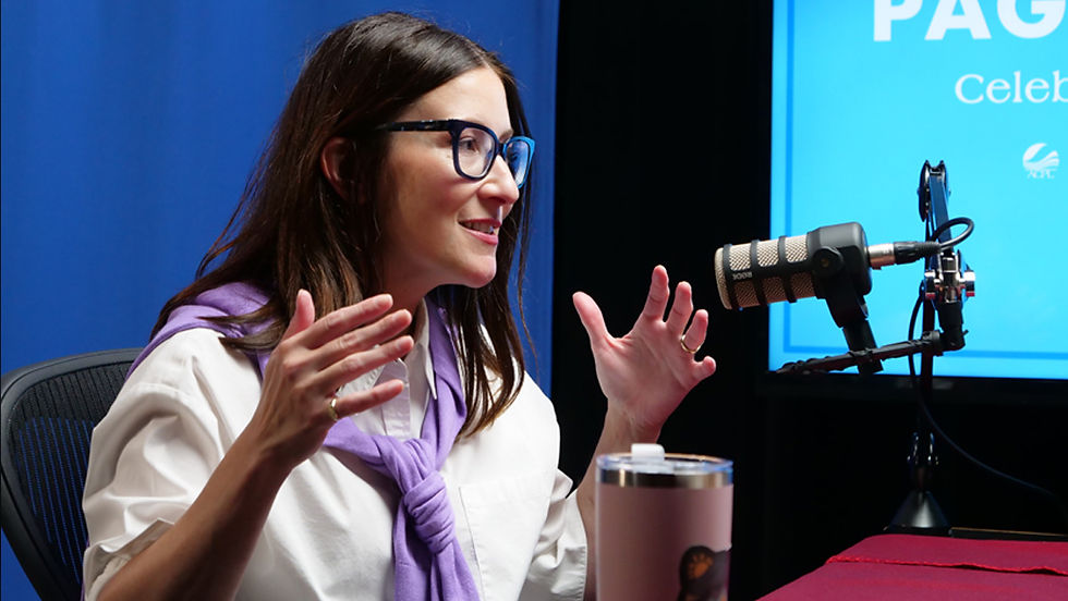 Meg Bell interviews local author Lisa Morton for the Pages & Voices podcast. Morton reads from her book while seated across from Bell in a studio with podcast microphones.
