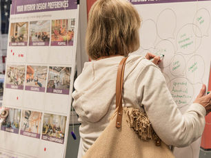 A woman writing on an engagement board during a listening session.