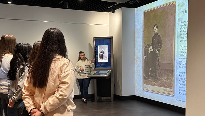 Grupo de estudiantes observando el retrato de Tad, el hijo de Abraham Lincoln.